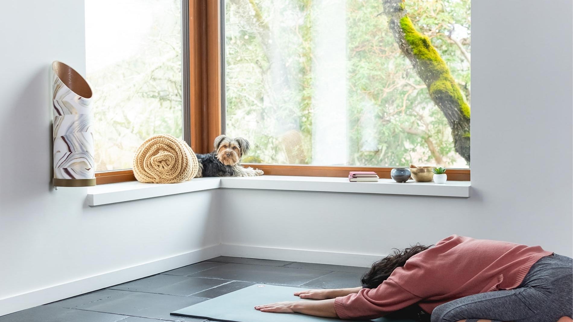 WOMAN PRACTICING YOGA IN HOME STUDIO WITH SUSTAINABLE PROP STORAGE