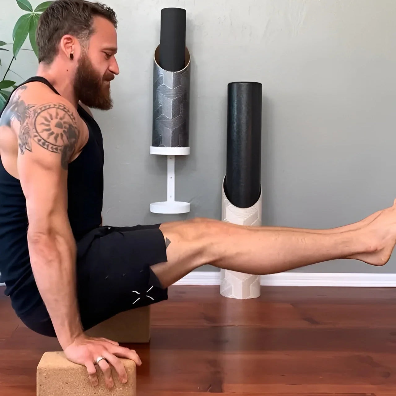A man doing yoga on Mache yoga blocks and a mat stored in a Mache tube, simplifying a two-prop morning stretch routine.