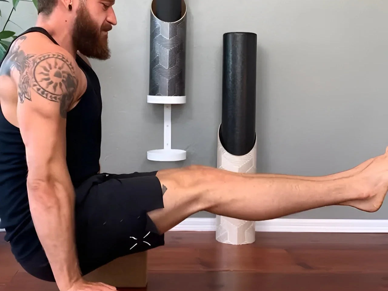 A man doing yoga on Mache yoga blocks and a mat stored in a Mache tube, simplifying a two-prop morning stretch routine.