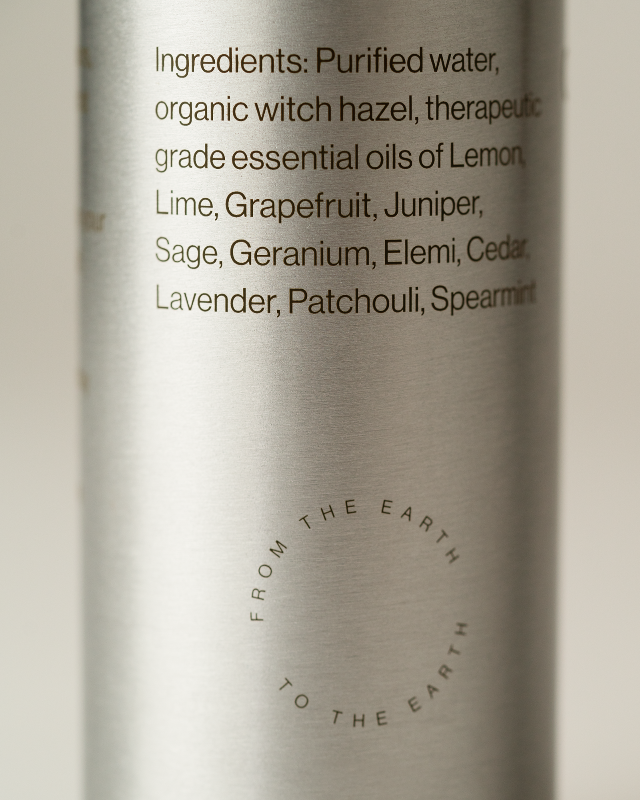 Silver bottle with text listing ingredients on a light background