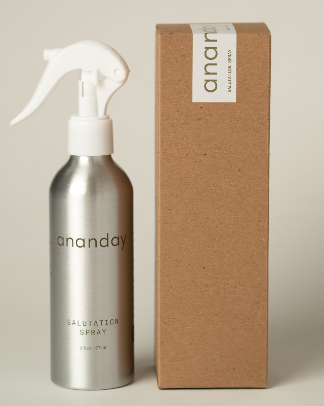 Silver 'ananday' salutation spray bottle with a cardboard box on a beige background