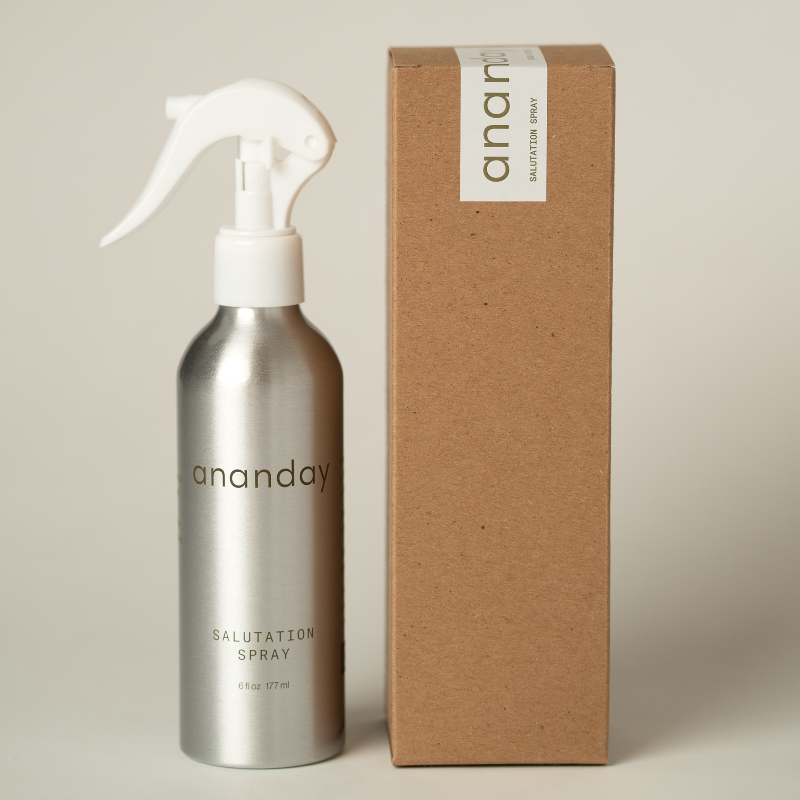 Silver 'ananday' salutation spray bottle with a cardboard box on a beige background