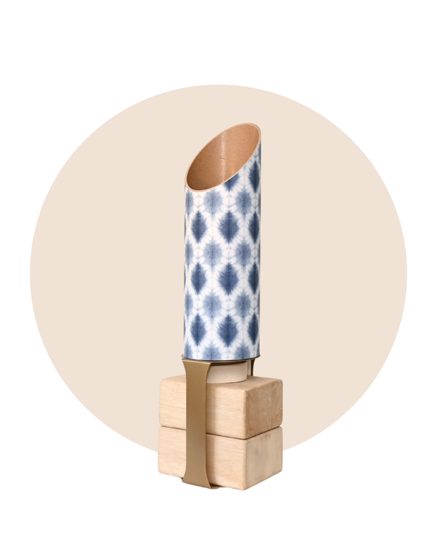 Decorative wall hook with a blue and white patterned cylindrical object on a beige background