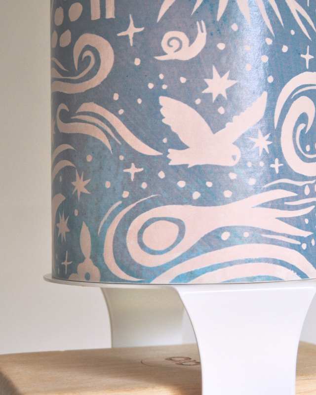 A yoga storage bundle consisting of a decorated yoga mat tube and white yoga block hardware, designed to hold yoga mat or foam roller, two yoga blocks, and a yoga strap.