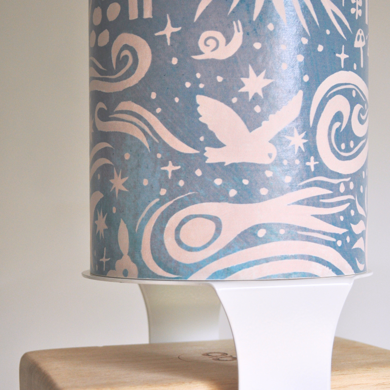 A yoga storage bundle consisting of a decorated yoga mat tube and white yoga block hardware, designed to hold yoga mat or foam roller, two yoga blocks, and a yoga strap.