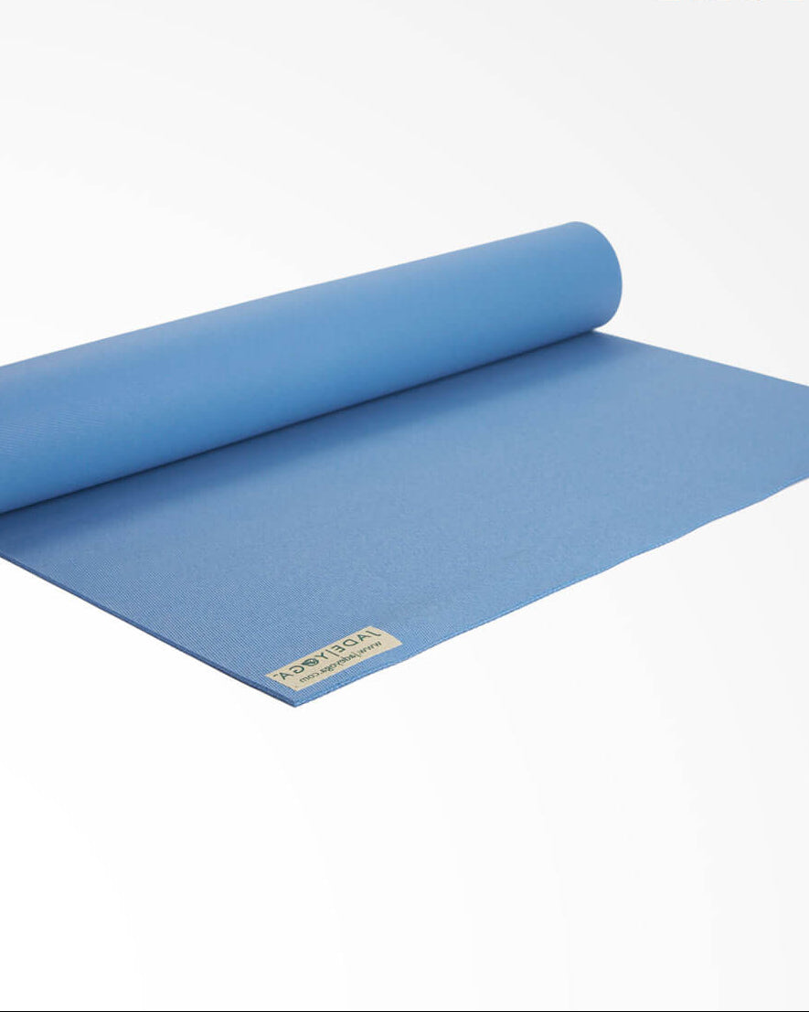 Rolling blue yoga mat with a brand label on a white background