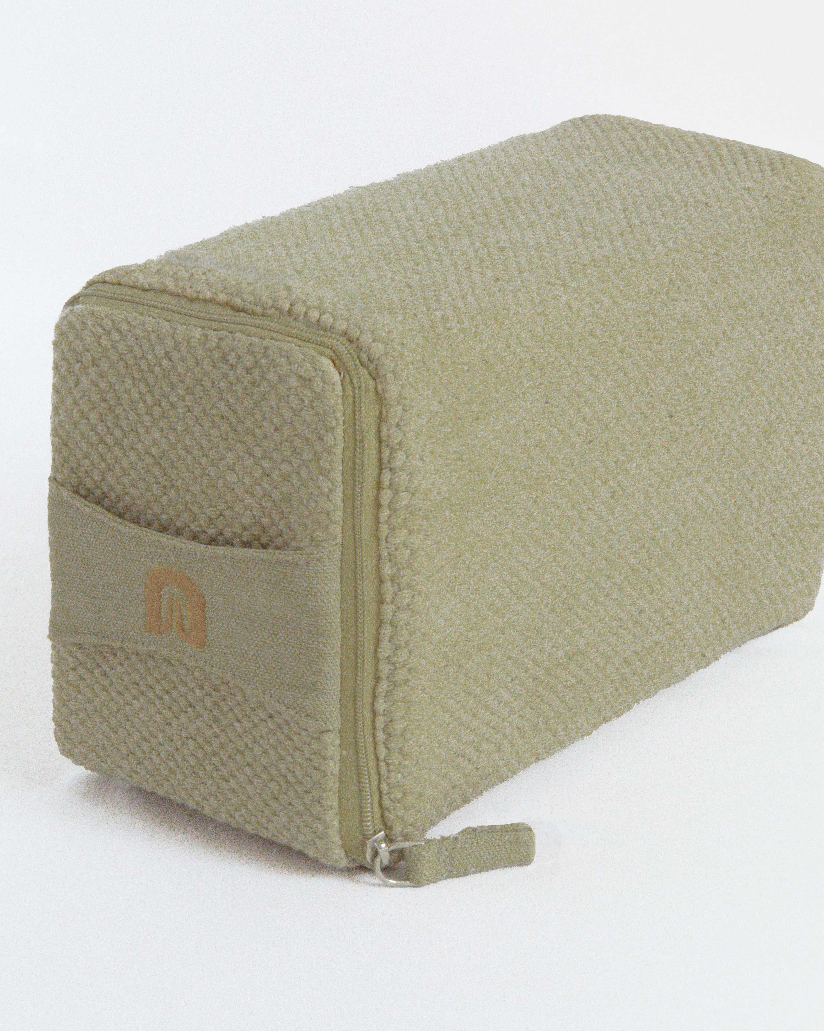 Green textured cotton yoga block with a brand logo on a white background