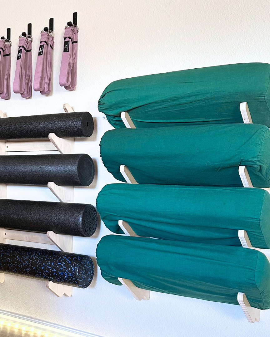 Foam rollers and yoga bolsters in wall rack