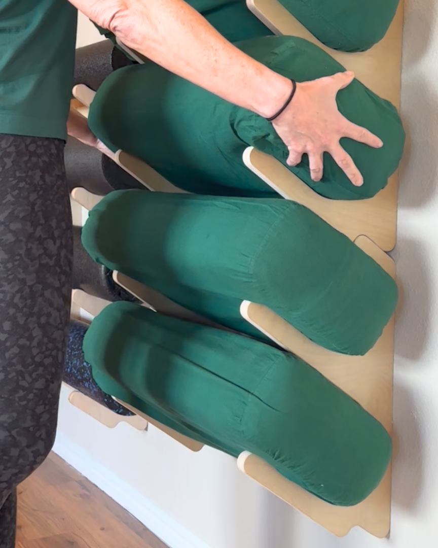person using yoga bolster wall organizer