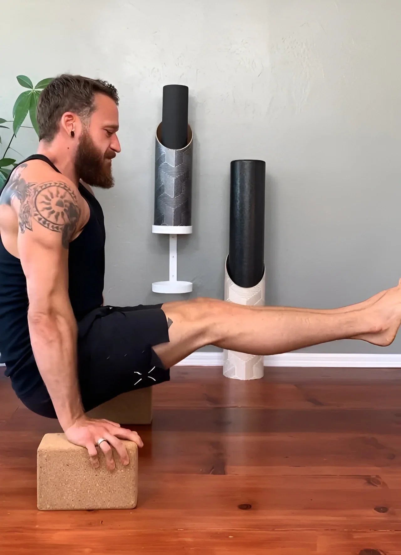 A man doing yoga on Mache yoga blocks and a mat stored in a Mache tube, simplifying a two-prop morning stretch routine.