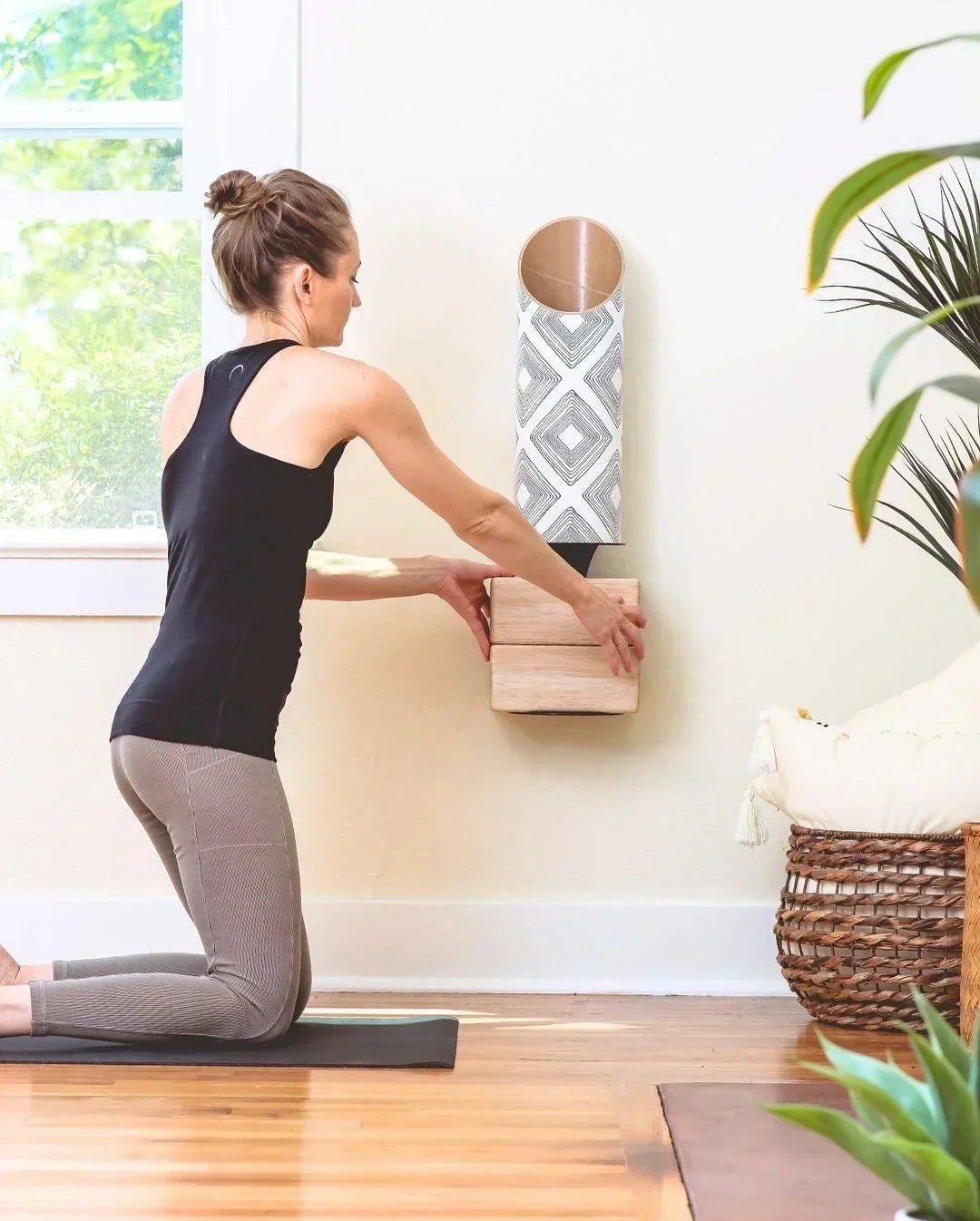 Woman making her yoga storage space by Mache, including a tube for yoga mats with an attached plate for the corks.