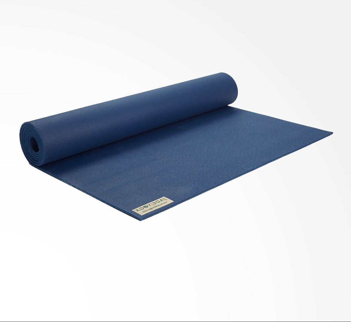 Rolling out midnight blue yoga mat on a white background