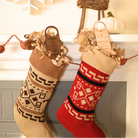 Two Christmas stockings, one red and one beige with patterns, hanging on a fireplace mantle.