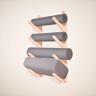 Wooden shelf with gray foam rollers and yoga mats on a beige background