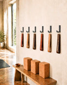 Yoke Hooks holding yoga straps on a yoga studio wall