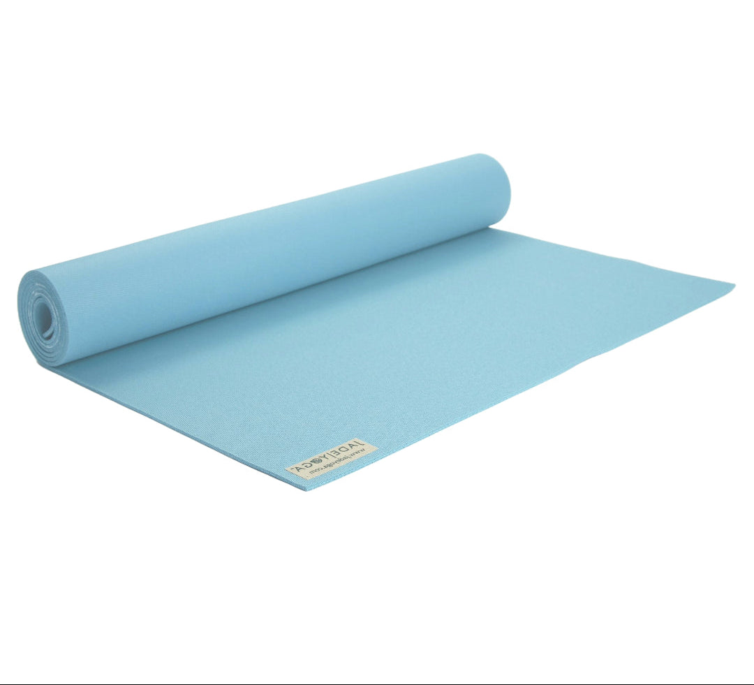Rolling sky blue yoga mat on a white background