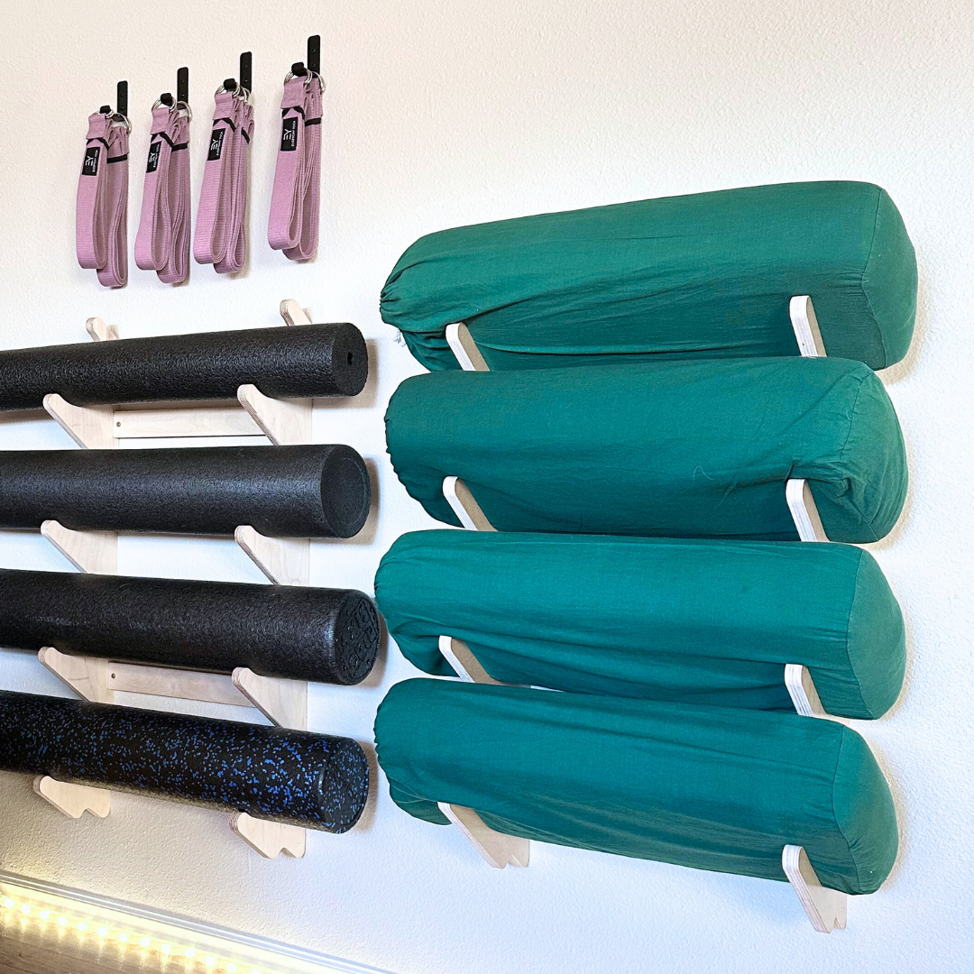 Foam rollers and yoga bolsters in wall rack
