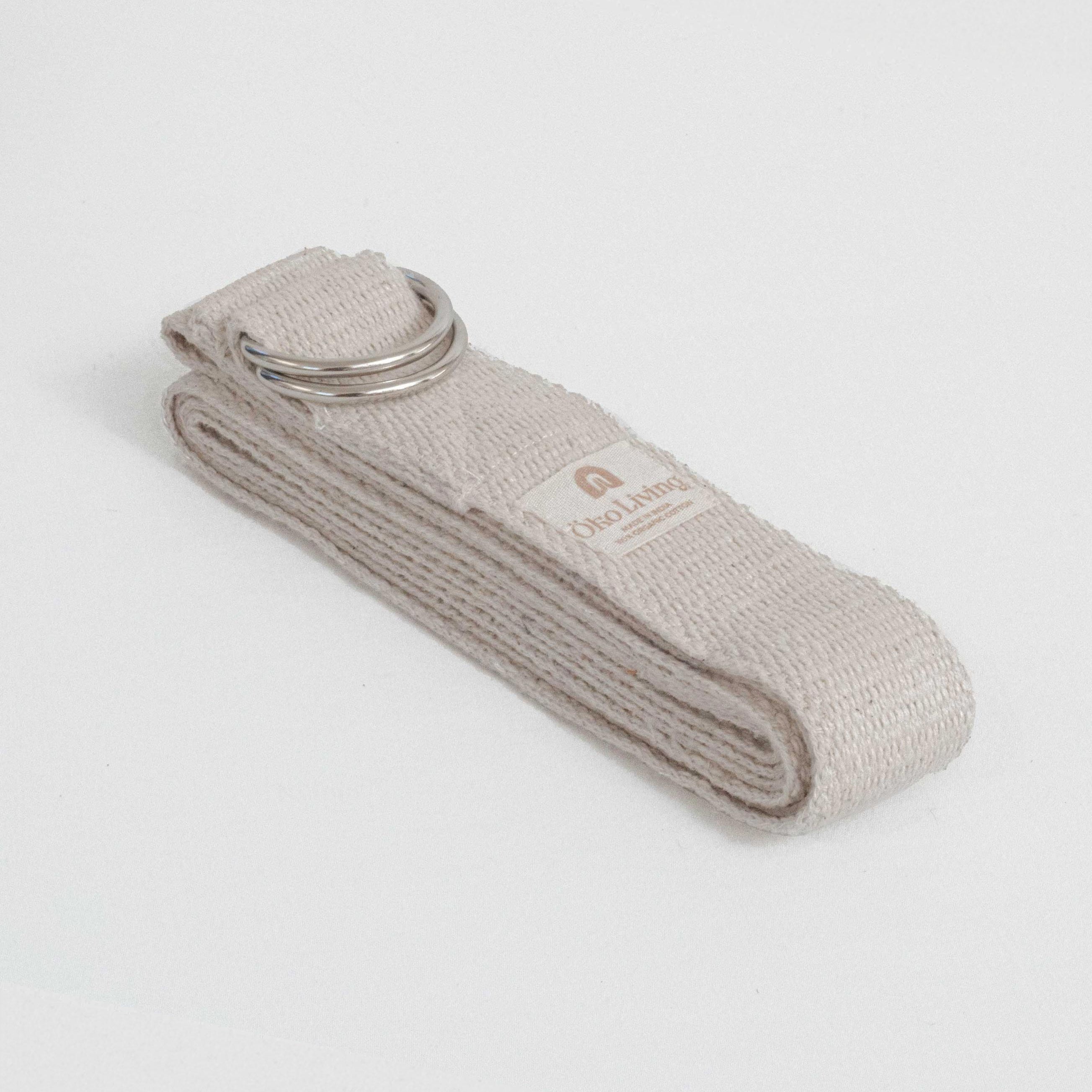 Beige yoga belt with a metal buckle on a light gray background